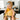 Baby in high chair holding yellow bear 360° teether to soothe gums