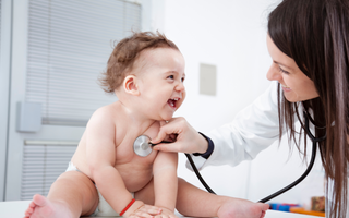 a doctor checking a baby's lungs with her stethoscope