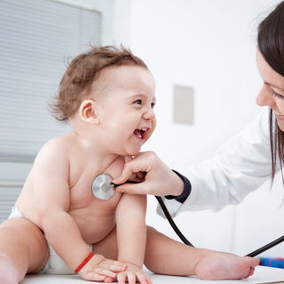 a doctor checking a baby's lungs with her stethoscope