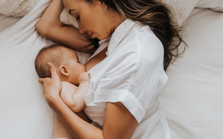 a mom breastfeeding her newborn baby