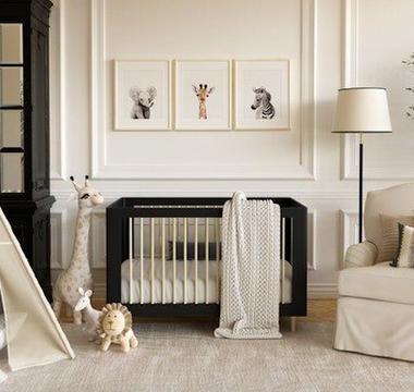 a baby nursery with white linen and a black crib