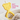 Yellow bear-shaped 360° teether with white bristles on plush textured blanket