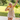Baby girl holding a yellow silicone teether while chewing outdoors
